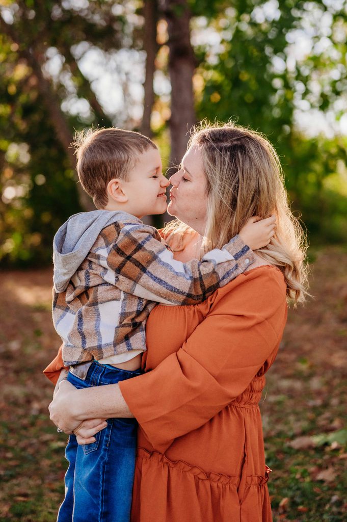 Mom and young son touching noses during an outdoor family photo session in Central Ohio.
